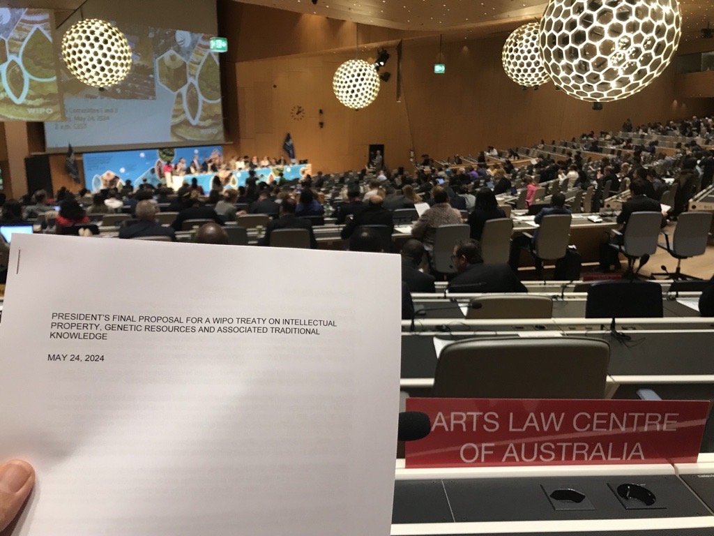 A room holding the WIPO Diplomatic Conference, delegates are seated. he forground shows a copy of the new treaty.